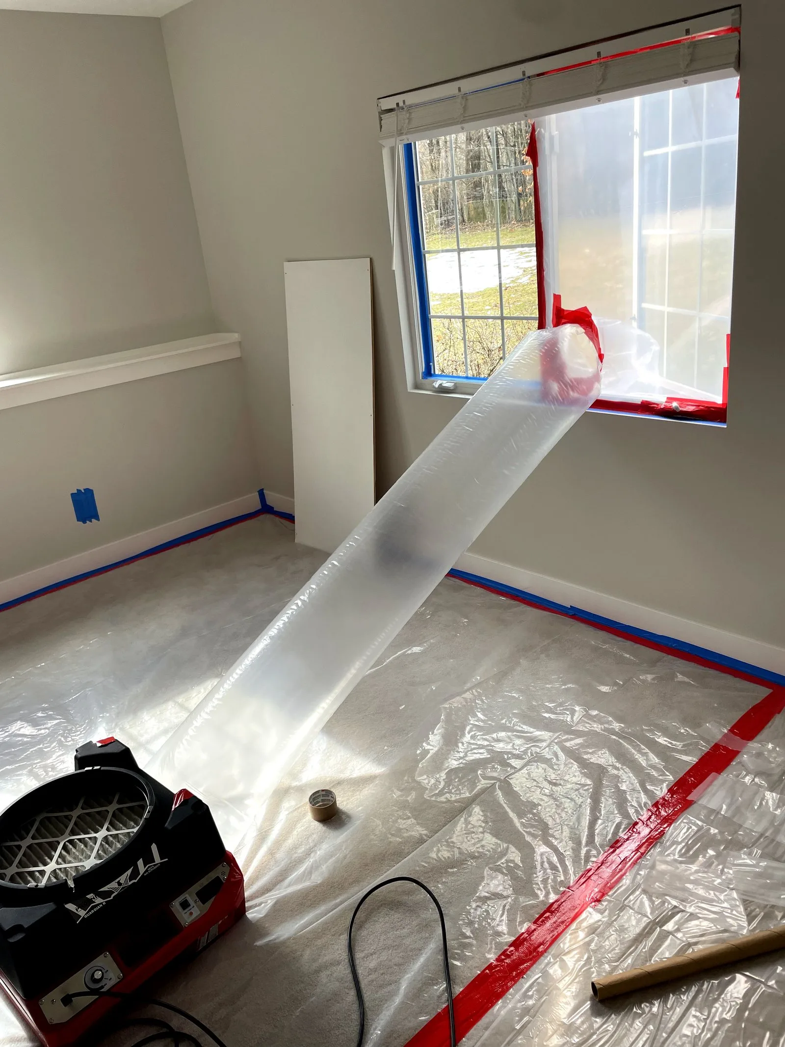 Air mover drying setup in bedroom after water damage — West Michigan