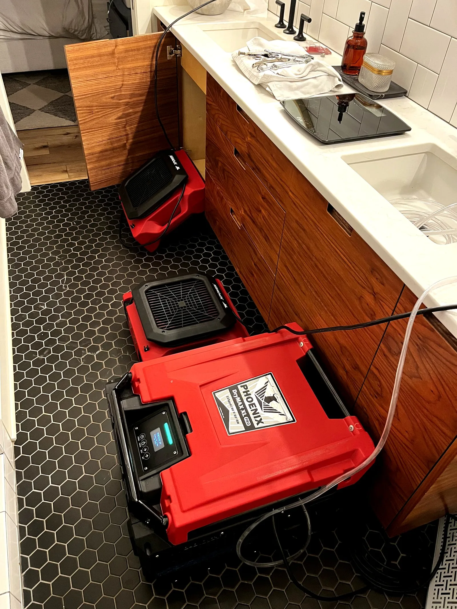 Commercial dehumidifiers running in water-damaged bathroom — Grand Rapids MI