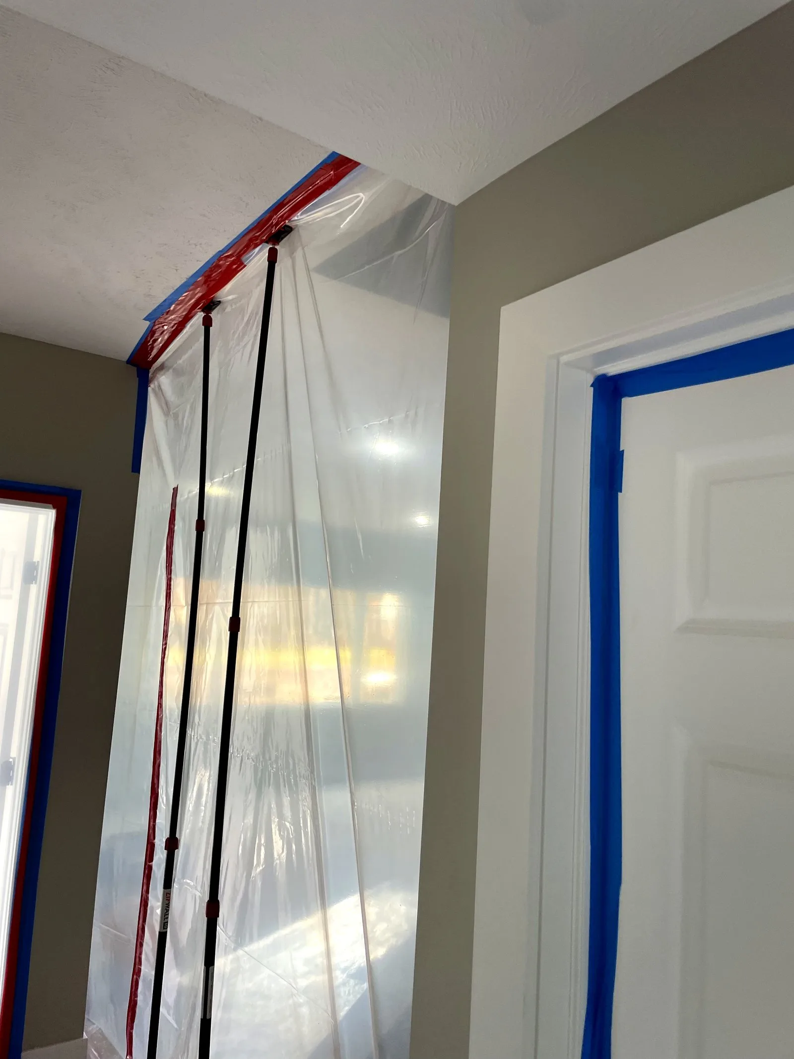 Professional containment barrier protecting home during restoration — Comstock Park, MI