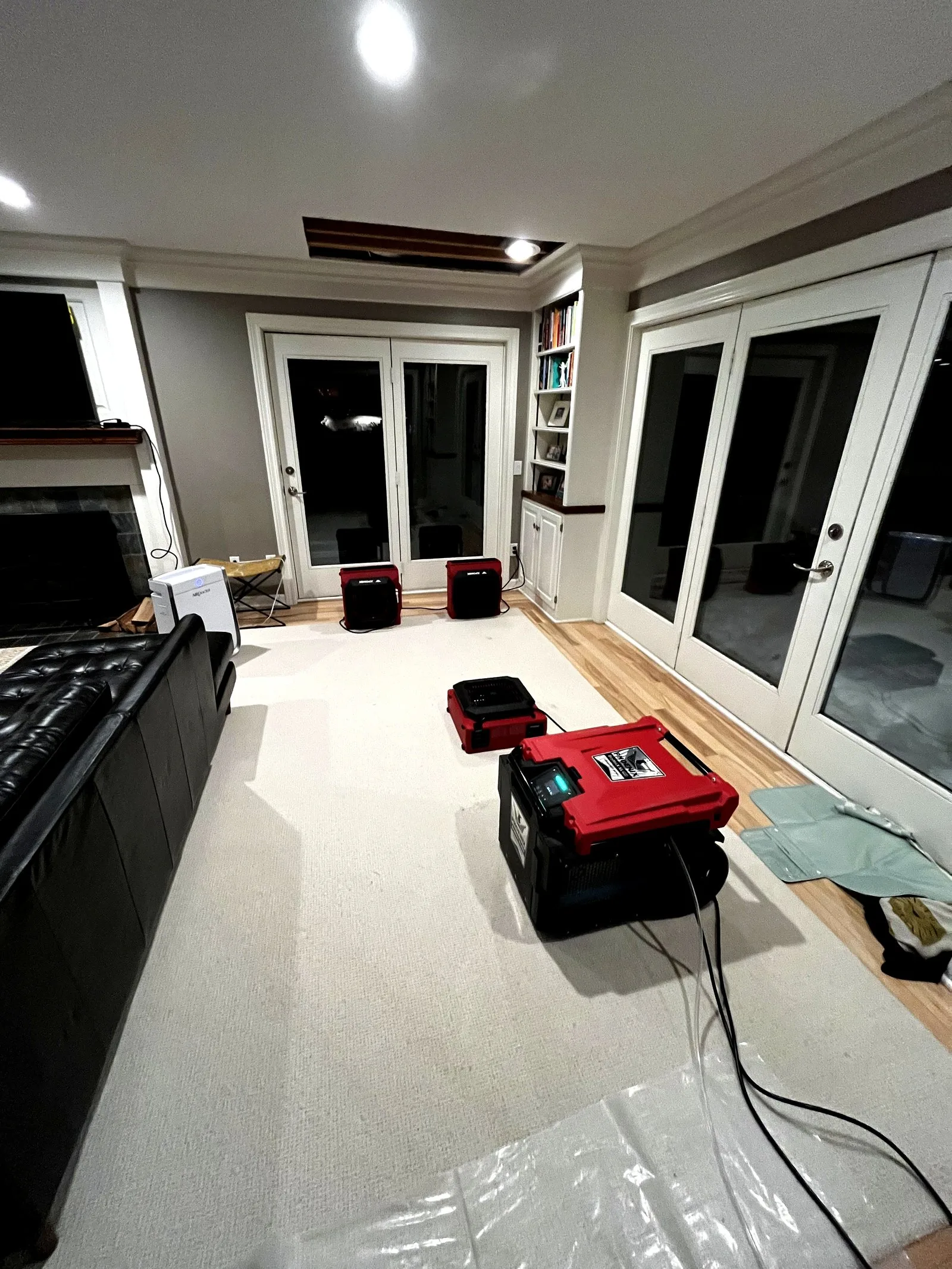 Air movers and dehumidifiers deployed for structural drying in Grand Rapids living room — Disaster Response by Ryan